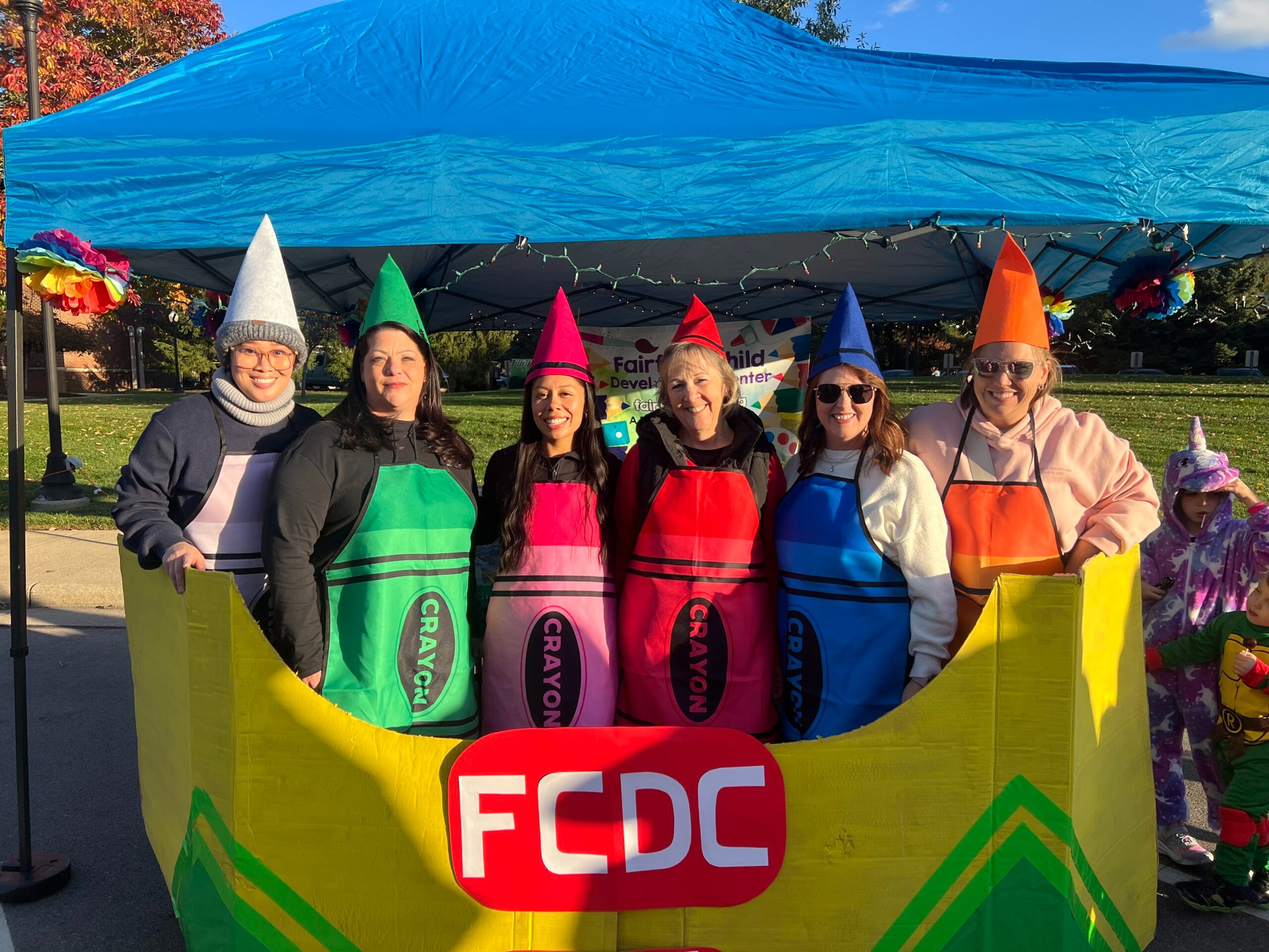 Fairfield Child Development Center team members dressed as colorful crayons at community event